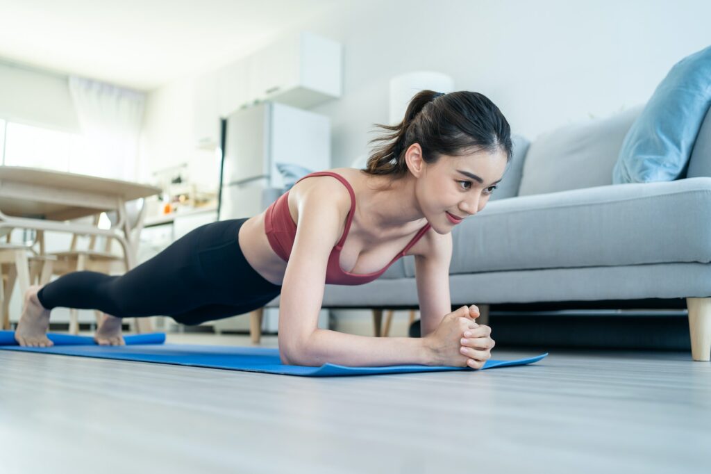 Asian Beautiful young woman stay home, doing cardio exercise for health in house